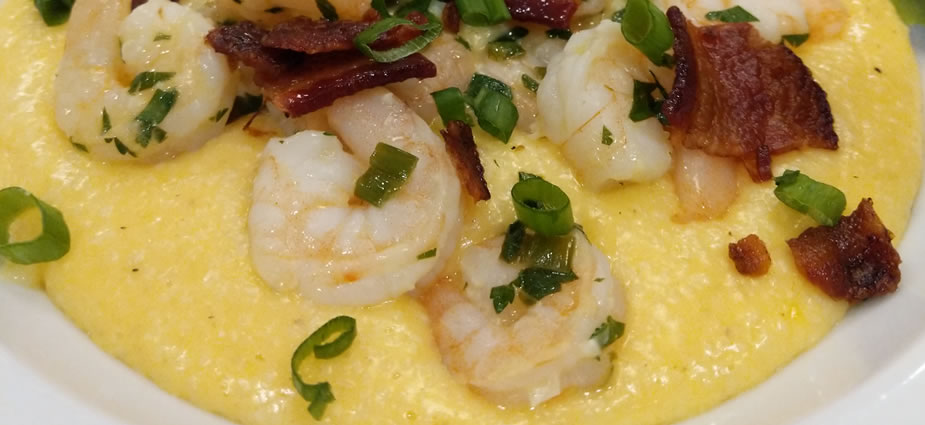 A homebrew and cheese infused grits covered in lemony shrimpers 